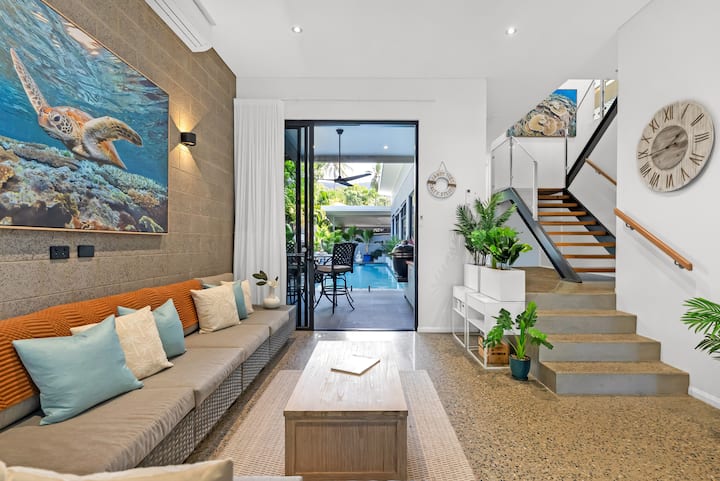 Entry foyer and sunken day lounge with large-scale reef photography by Josh Whiting.