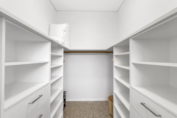 Walk-in robe with open shelving.