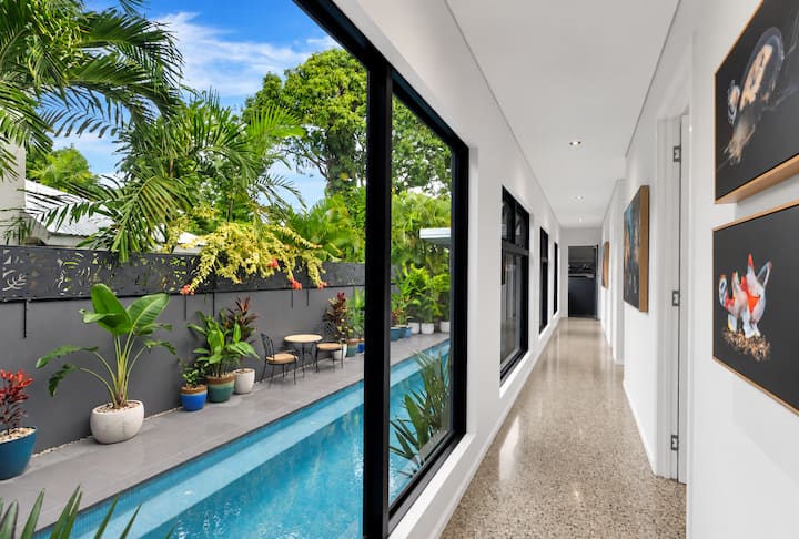 Long hallway with glass along one side looking onto the pool.
