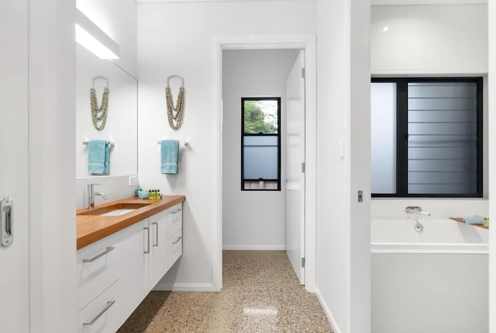 Main bathroom vanity zone, with doors to separate toilet and bathing rooms.