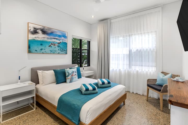 Hatchling Room with a king bed and a reef photograph.