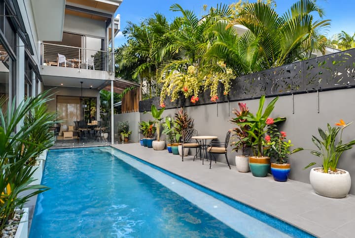 Pool and terrace seen from the house, with balconies above.